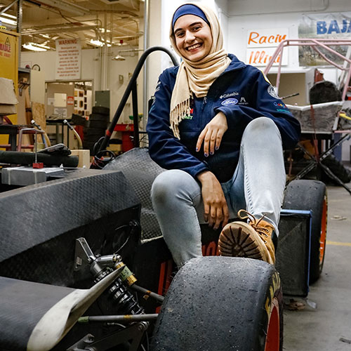 Aerospace Engineering senior Salam Mulhem shows off one of Formula SAE Illini Motorsports vehicles.